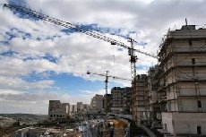 Olmert vows to continue building settlements   